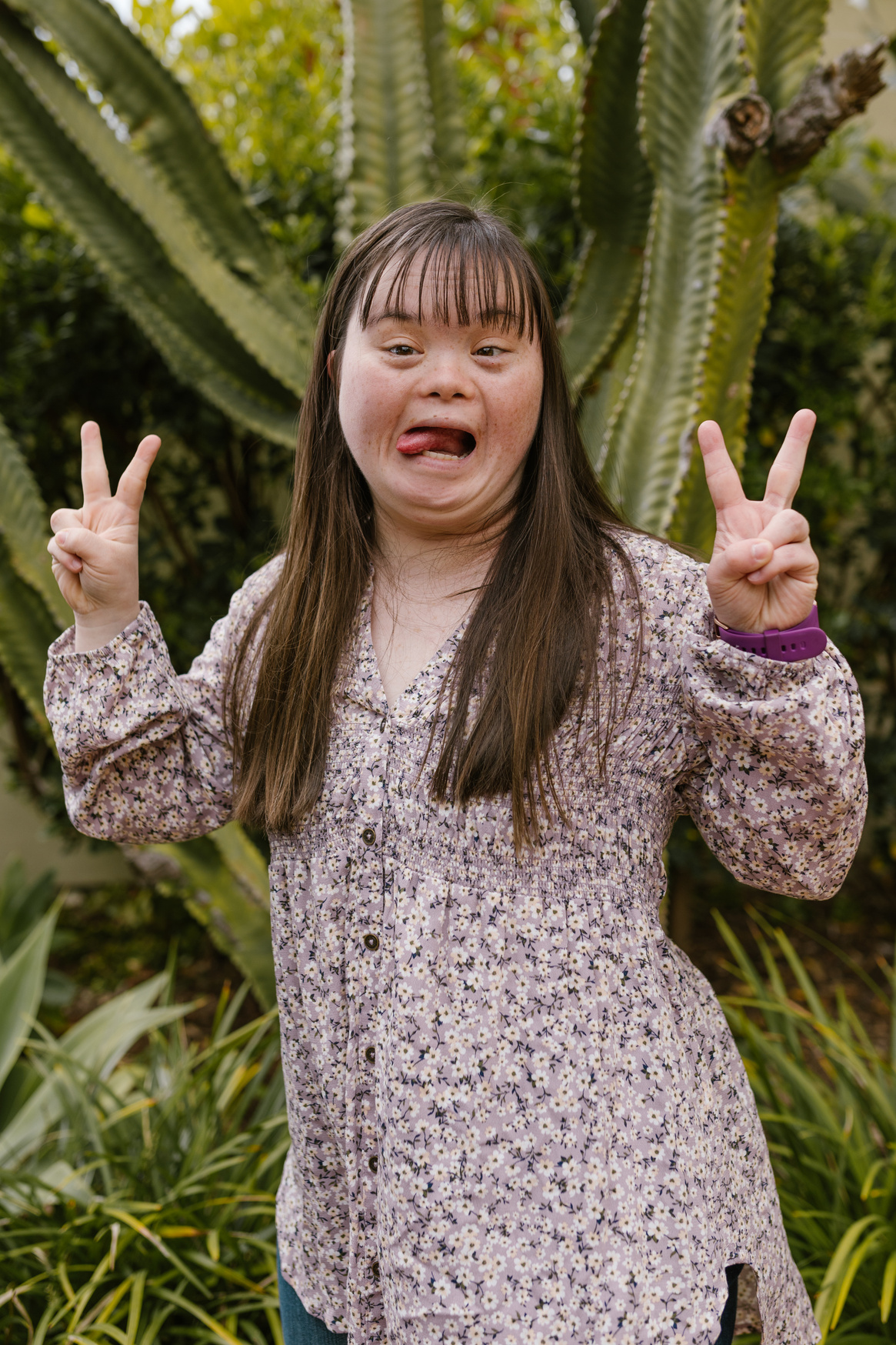 Woman in Floral Top Doing Peace Sign